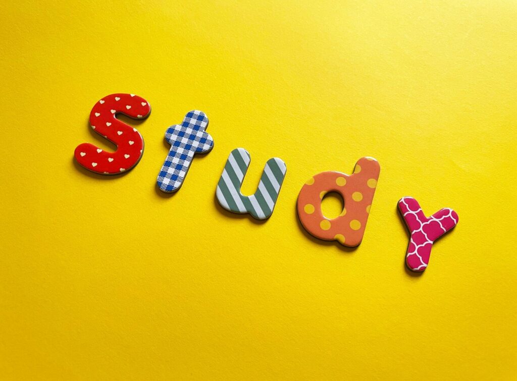 a word made out of wooden letters sitting on top of a yellow surface